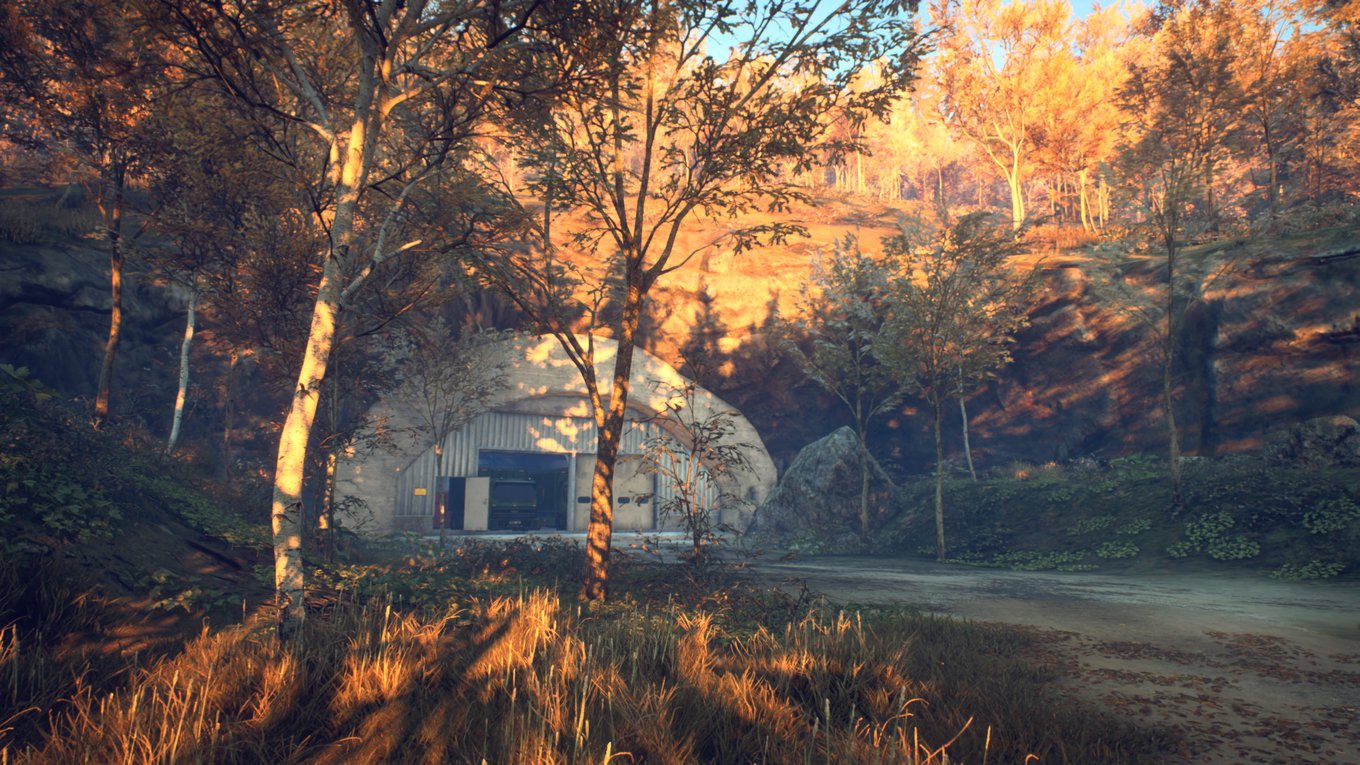 Ein Xbox Screenshot aus dem Spiel Generation Zero. Zu sehen ist ein in den Berg eingelassener Bunkereingang im Sonnenaufgang, der die Szene in ein warmes Licht taucht.